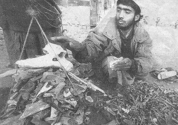 A man weighing human bones for export to Pakistan