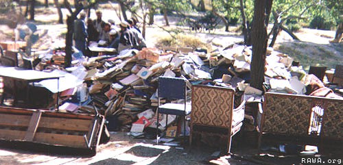 Forced of Ahmad Shah Masoud piled books in order to set them ablaze in Kabul University.