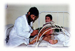 A doctor treats landmine victim in the hospital