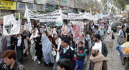 RAWA activists carry on the logo of RAWA even it has been torn by Pakistani police.