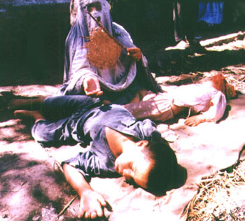 Afghan woman in Kabul with her children