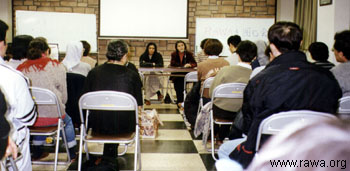 Saba and Maryam talking to a group of people