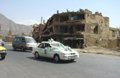 Wedding party passes a destroyed area of Debori