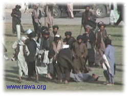 Taliban carry the dead body of the victim