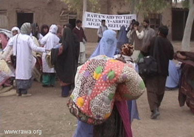 RAWA activists distribute the quilts