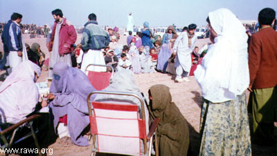 A RAWA mobile health care team among new refugees. More than 400 women and children were provided with medicines and the doctors also checked the patients.