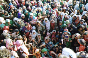 Hundreds of women rush to receive food from RAWA